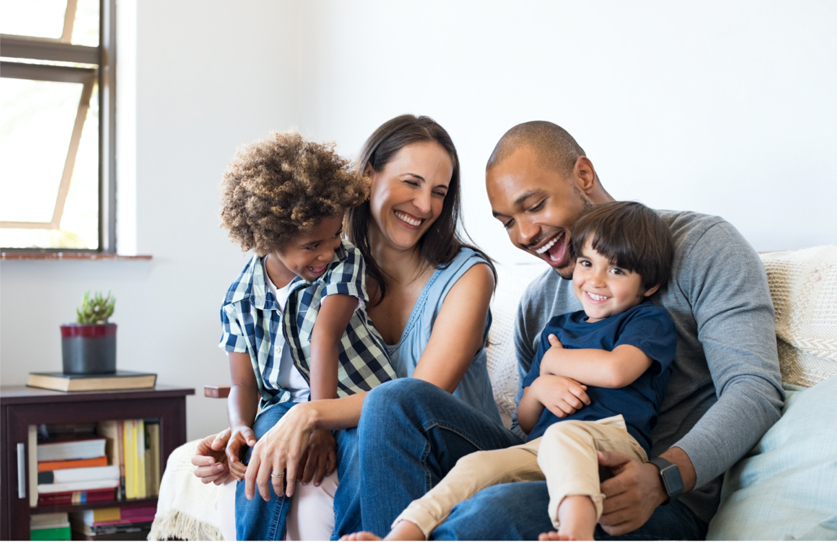 family laughing on couch